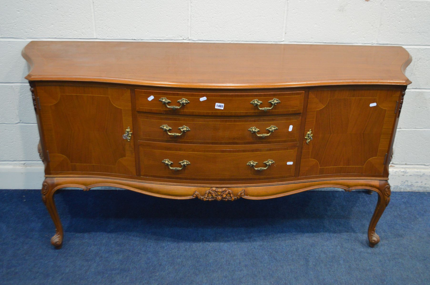 A REPRODUCTION BRIDGECRAFT MAHOGANY AND CROSSBANDED SERPENTINE SIDEBOARD, with two cupboard doors