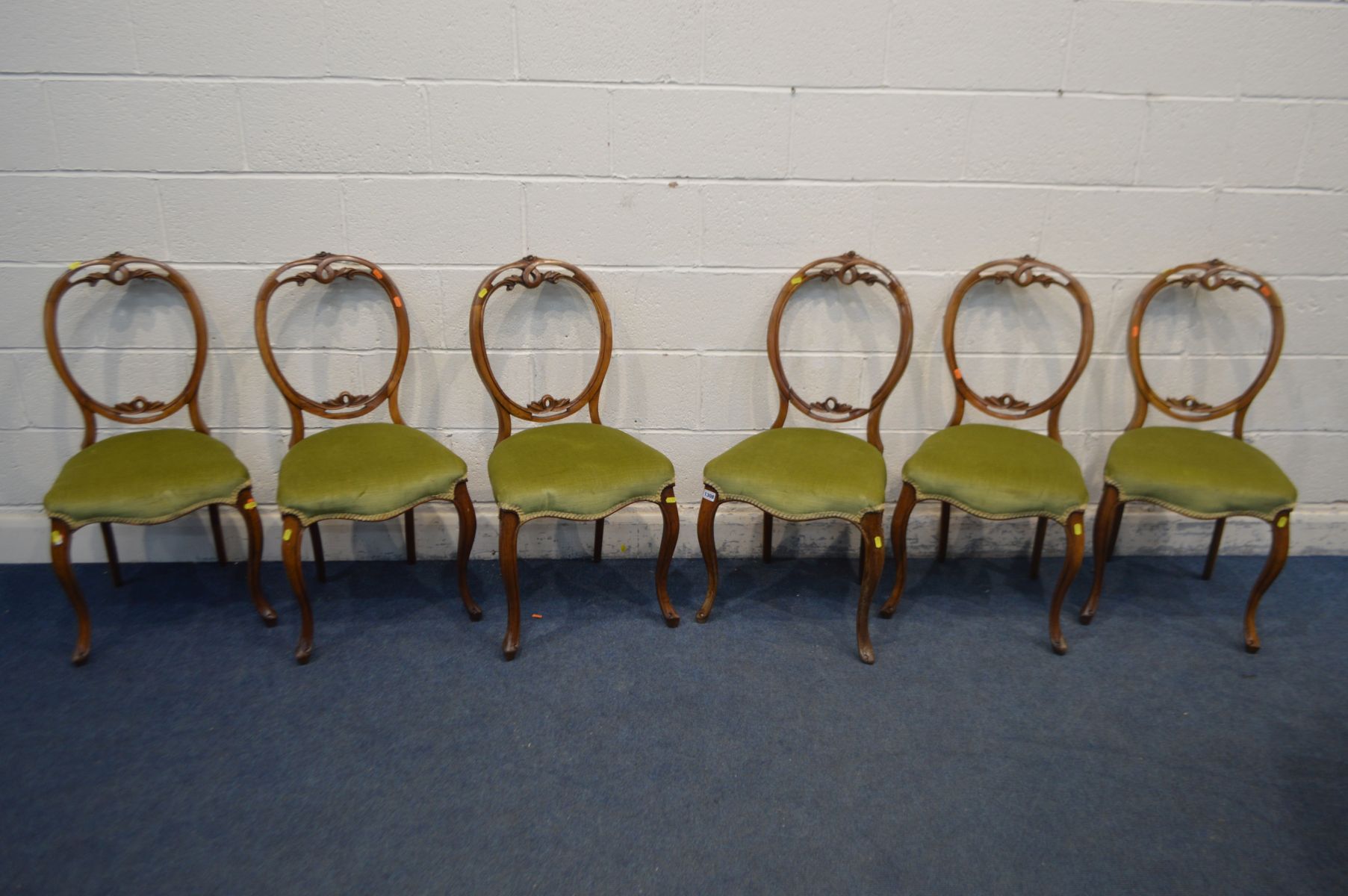 A SET OF SIX VICTORIAN WALNUT BALLON BACK CHAIRS, with foliate cresting rail, green upholstered seat