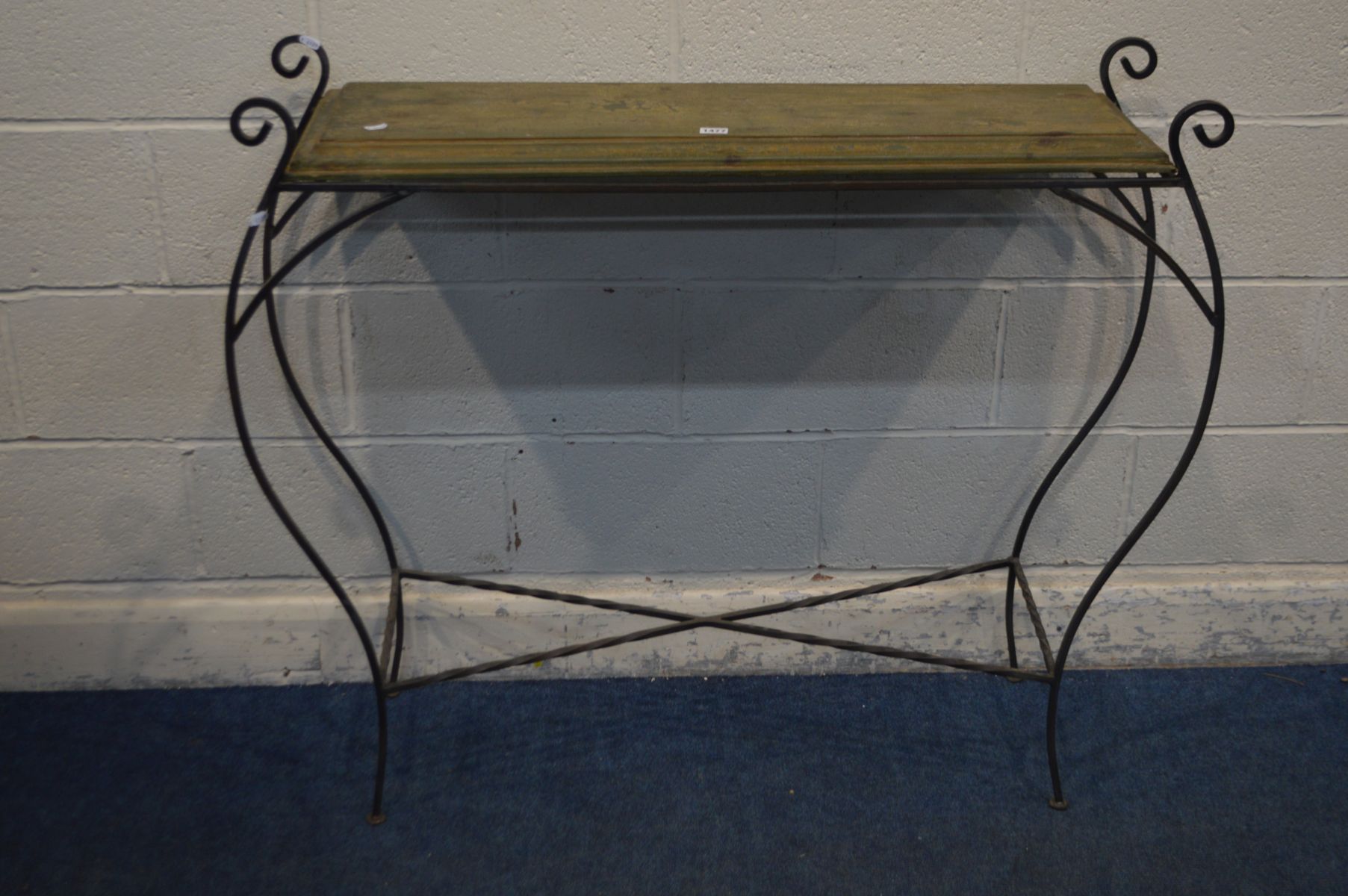 A SCROLLED WROUGHT IRON HALL TABLE with a rustic top, width 116cm x depth 31cm x height 97cm