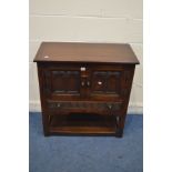 AN OAK TWO DOOR CABINET, above a single long drawer, and an undershelf, width 82cm x depth 41cm x