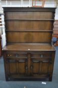 AN OAK DRESSER with two drawers, width 123cm x depth 44cm x height 173cm