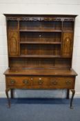 A GEORGE III STYLE OAK DRESSER, the top with a wavy apron to the top, twin single doors, over a base