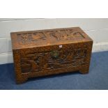 AN ORIENTAL HEAVILY CARVED CAMPHOR WOOD CHEST, decorated with marine scenes, width 94cm x depth 45cm