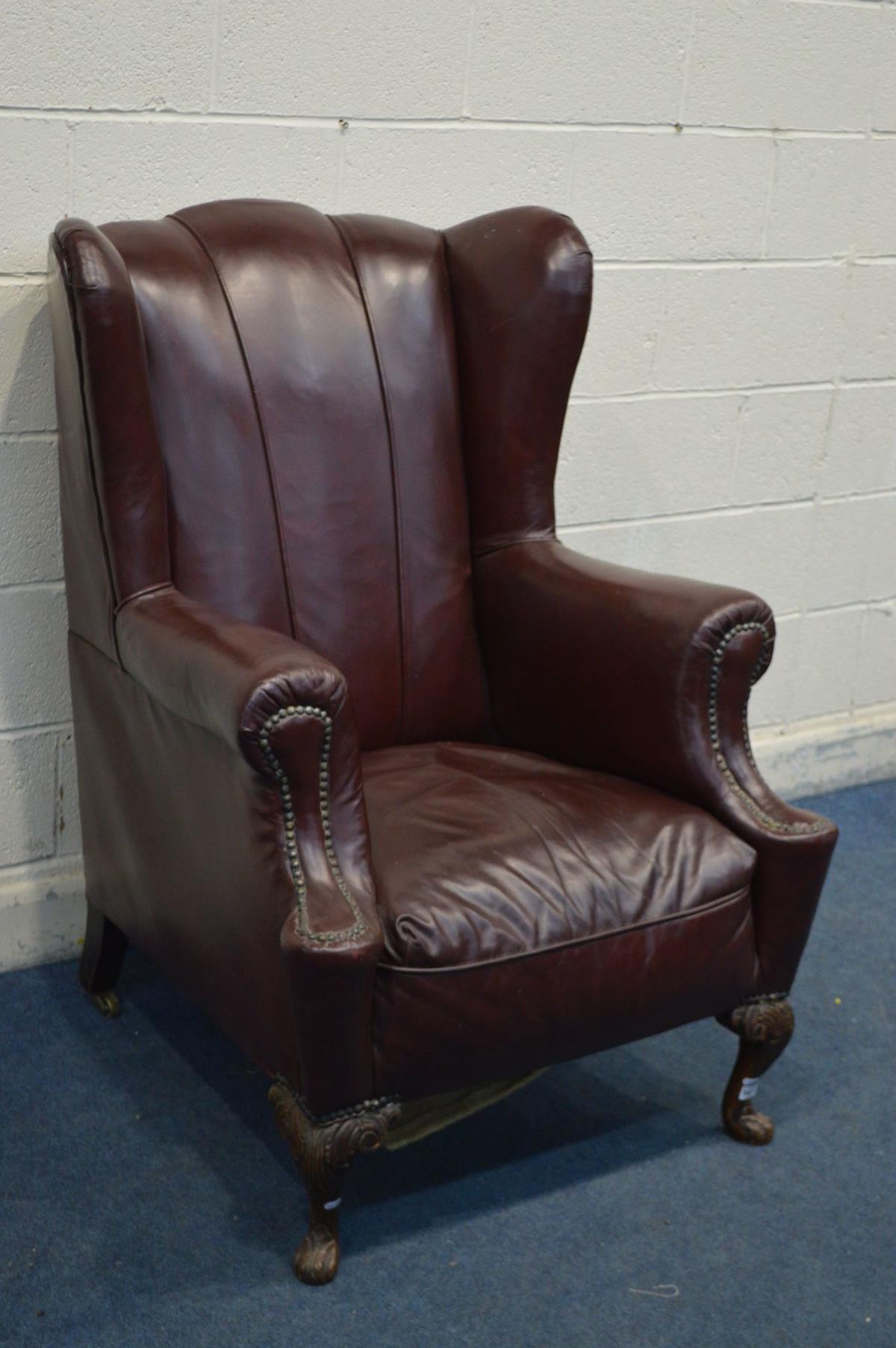 A GEORGE III GENTLEMANS ARMCHAIR, recovered in burgundy faux leather upholstery, sprung seat, on