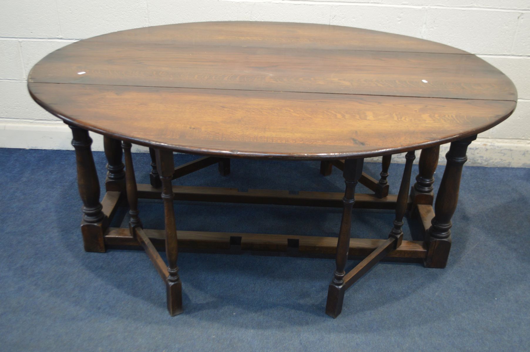 A 18TH CENTURY STYLE OAK WAKE TABLE, oval top with fall leaves, on turned and block legs, length
