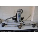 A PROTEAMS QUARTER VAC VACUUM CLEANER with back harness and two spare heads (not tested due to non