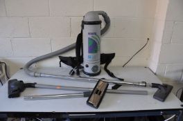 A PROTEAMS QUARTER VAC VACUUM CLEANER with back harness and two spare heads (not tested due to non