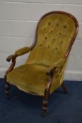A DISTRESSED VICTORIAN OPEN ARMCHAIR