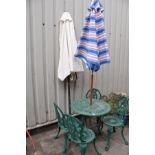 A GREEN PAINTED CAST ALUMINIUM GARDEN TABLE, four similar chairs and two parasols