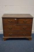 A DISTRESSED GEORGIAN OAK AND MAHOGANY CHEST OF TWO OVER TWO LONG DRAWERS, with swan neck handles on