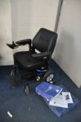 A ROMA MOBILITY RENO ELITE ELECTRIC WHEELCHAIR with charger, manual and seat pad in like new