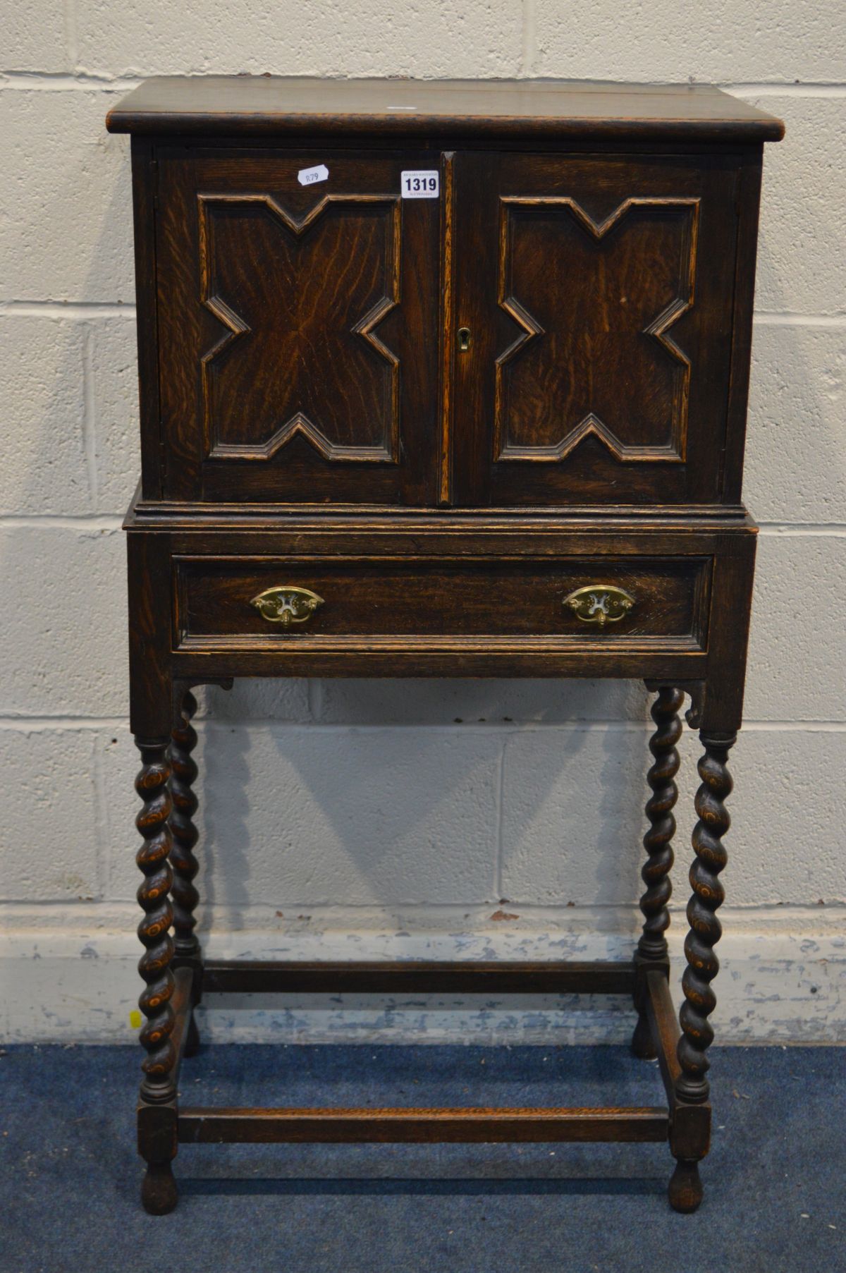 AN EARLY 20TH CENTURY OAK TWO DOOR CABINET, single drawer, on barley twist legs united by - Image 2 of 3