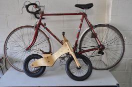 A RED VINTAGE VISCOUNT SEBRING INTERNATIONAL ROAD BIKE together with a wooden Early Rider balance