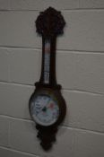 AN EDWARDIAN OAK ANEROID BAROMETER