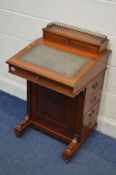 AN EDWARDIAN WALNUT DAVENPORT, with a hinged storage compartment, blue leather inlay, four drawer to