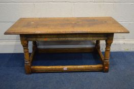 A REPRODUCTION OAK RECTANGULAR COFFEE TABLE, a turned support united by stretchers, length 107cm x