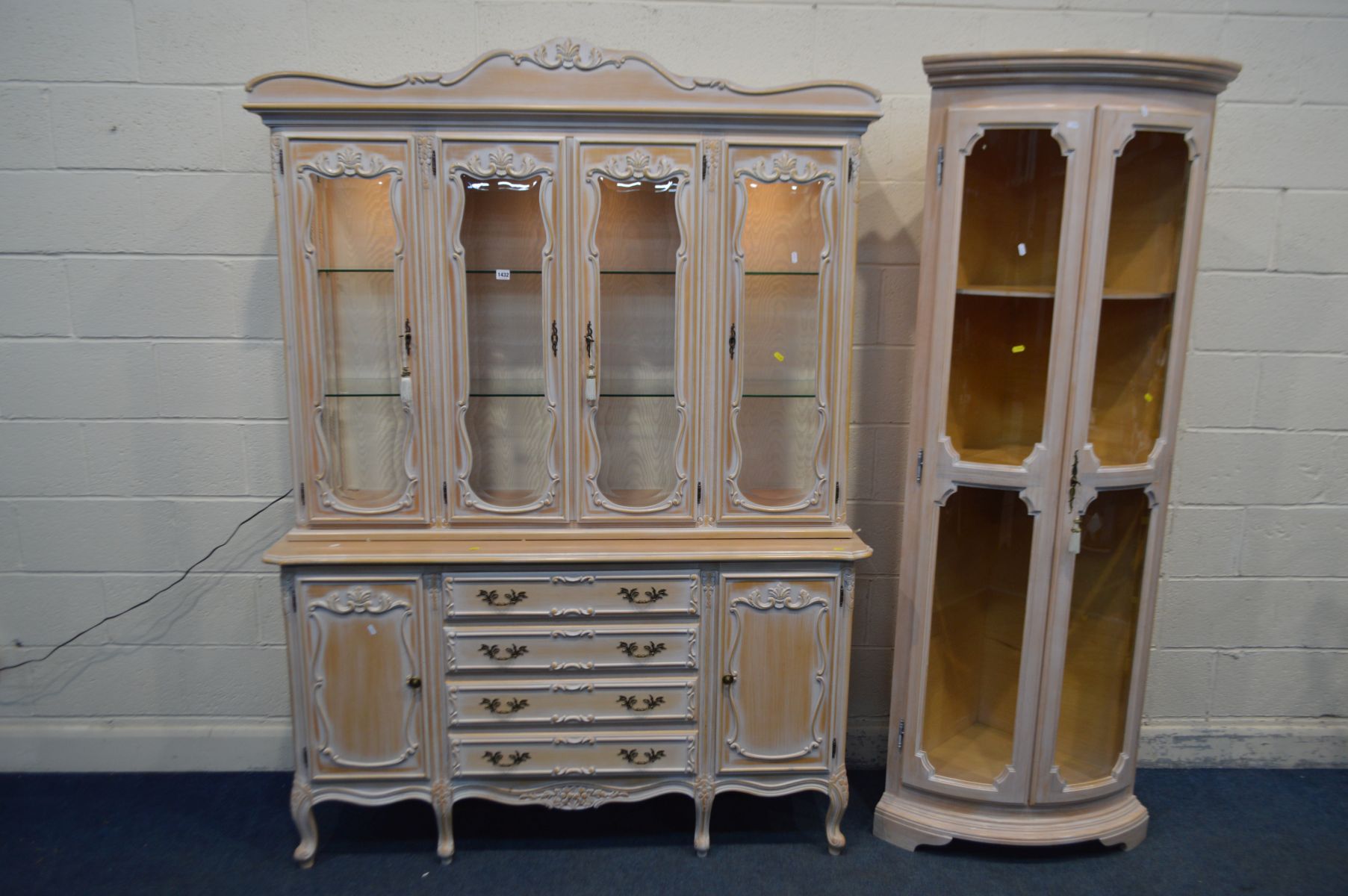 A BLEACHED FINISH ITALIAN FOUR DOOR DISPLAY CABINET, with four central drawers, width 149cm x