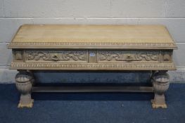 A LOW STRIPPED CARVED OAK SIDE TABLE, with two drawers, width 125cm x depth 44cm x height 58cm