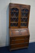 A DISTRESSED OAK LEAD GLAZED BUREAU BOOKCASE, width 91cm x depth 43cm x height 196cm