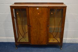 A 1930'S WALNUT SIDE BY SIDE BOOKCASE with a central cupboard door, width 119cm x depth 34cm x