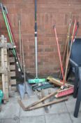 A PLASTIC WHEEL BARROW, a manual lawn aerator and various garden tools