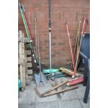 A PLASTIC WHEEL BARROW, a manual lawn aerator and various garden tools