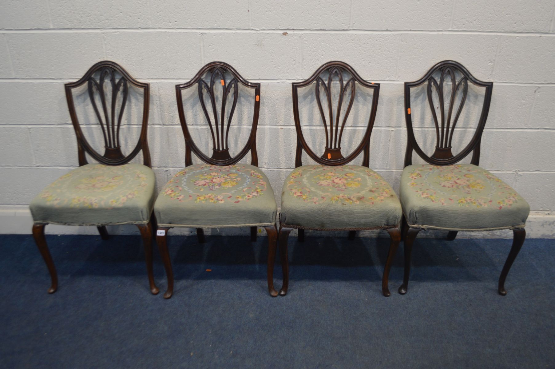 A SET OF FOUR 19TH CENTURY MAHOGANY CHAIRS, with a gothic style back, needlework upholstery on