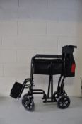 AN ALL AID FOLDING WHEEL CHAIR with footrests (still has its tyre protectors fitted)