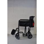 AN ALL AID FOLDING WHEEL CHAIR with footrests (still has its tyre protectors fitted)