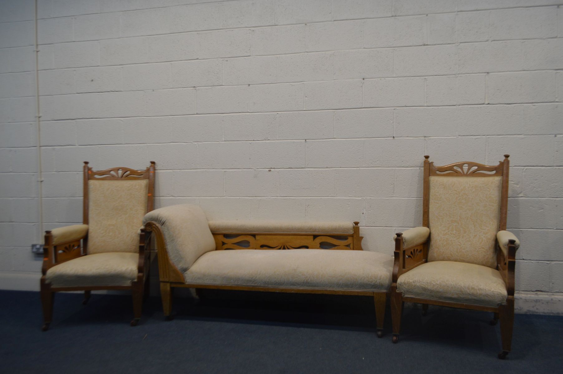 AN EARLY 20TH CENTURY GOLDEN OAK THREE PIECE SUITE PARLOUR SUITE, with foliate upholstery,