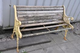 A DISTRESSED GARDEN BENCH with cast iron ends and slatted seat and back (some slats missing) 126cm