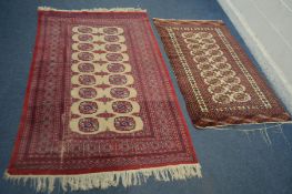 A TURKOMAN TEKKE RED GROUND RUG, 207cm x 124cm - and a similar smaller rug, 161 cm x 94cm (2)