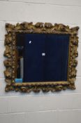 A 19TH CENTURY GILTWOOD WALL MIRROR, open foliate rococo rectangular frame, approximate frame size