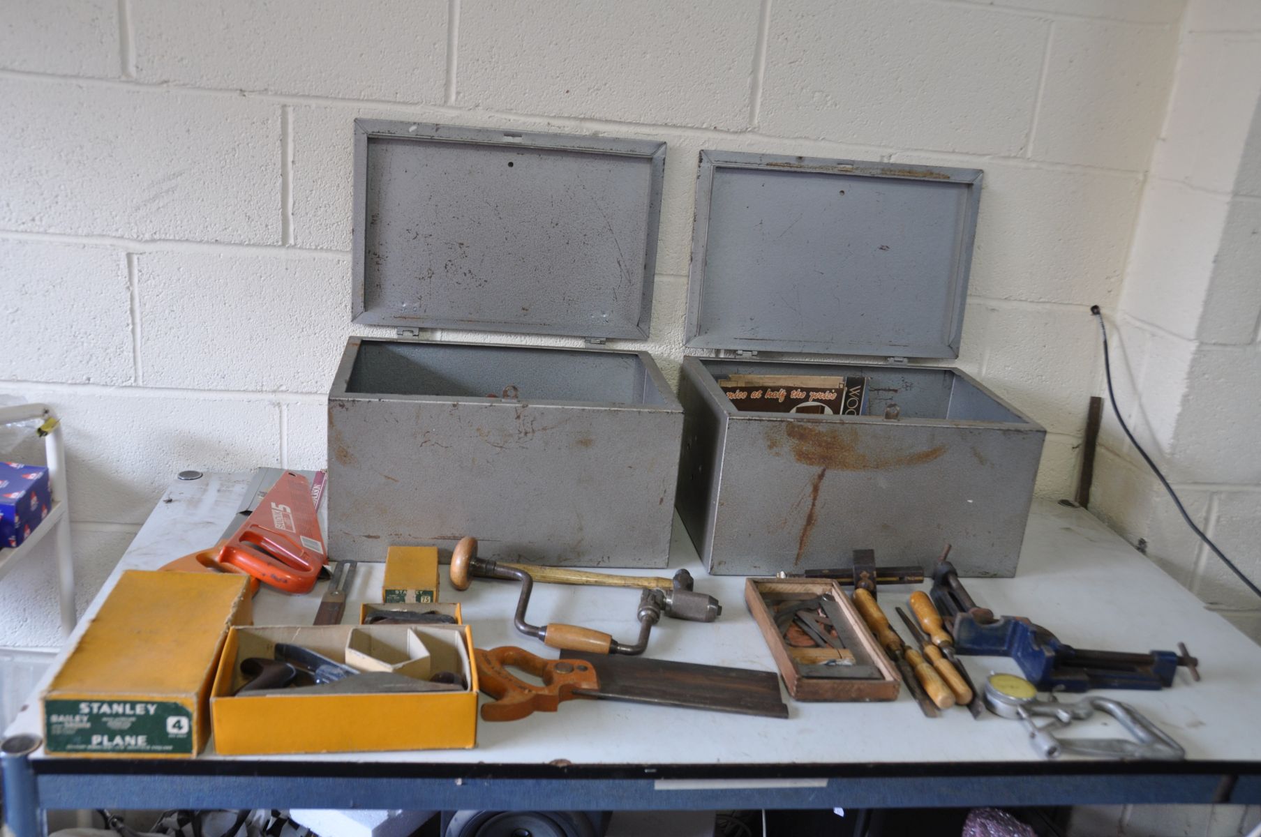 TWO METAL LIDDED BOXES containing carpenters tools including a boxed Stanley No4 plane, a boxed