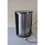 A BUFFALO UK ROUND PLATE HEATER with rotary sliding door and shelves, 43cm in diameter and 59cm