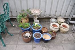 A TERRACOTTA HERB POT, seven glazed plant pots, four composite plant pots and a Cherub Bird Bath