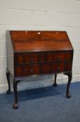 A MAHOGANY LADIES BUREAU with a fitted interior, three various drawers, on cabriole legs and ball