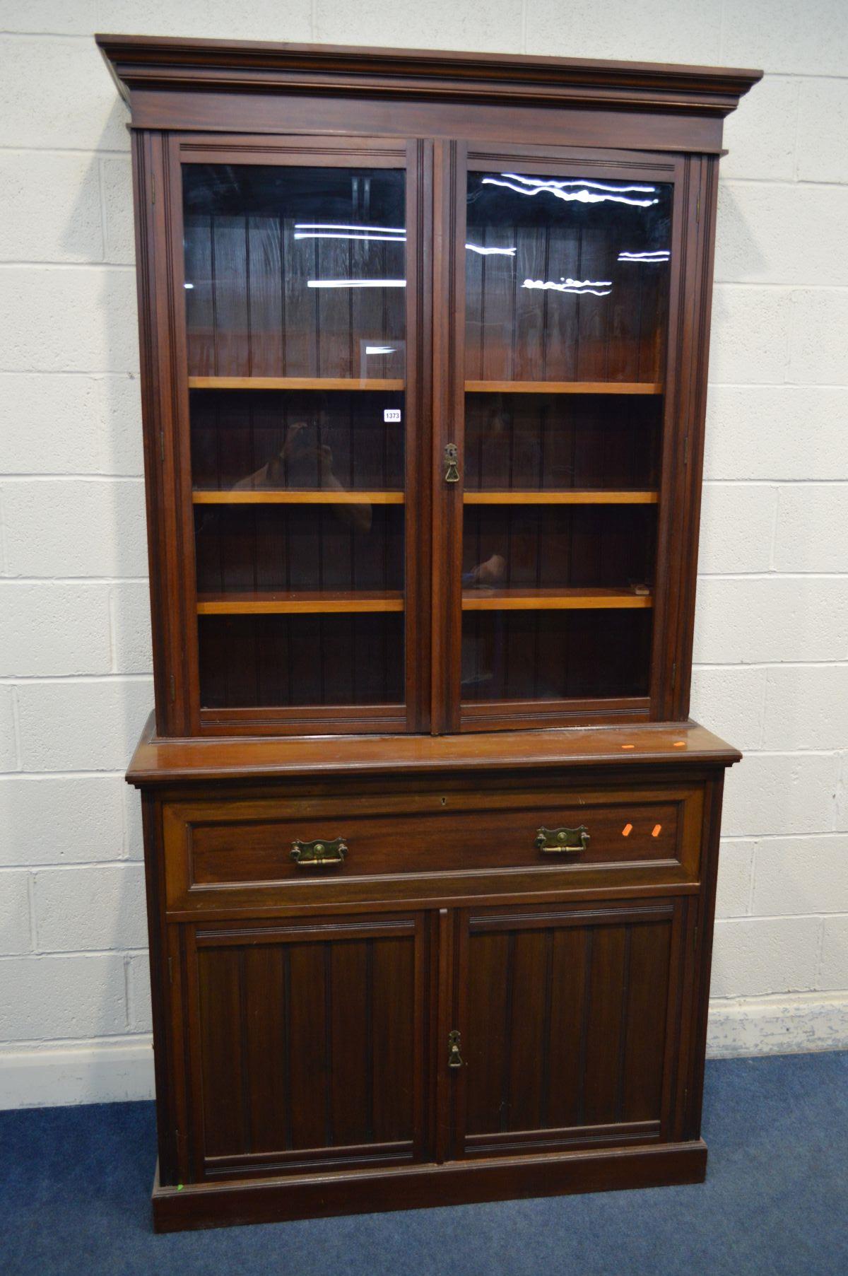 AN EDWARDIAN WALNUT SECRETAIRE BOOKCASE with double glazed doors enclosing three adjustable