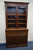 AN EDWARDIAN WALNUT SECRETAIRE BOOKCASE with double glazed doors enclosing three adjustable