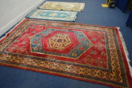 A WOOLLEN RED GROUND SARAB RUG, 276cm x 183cm (staining) and two Chinese rugs (3)