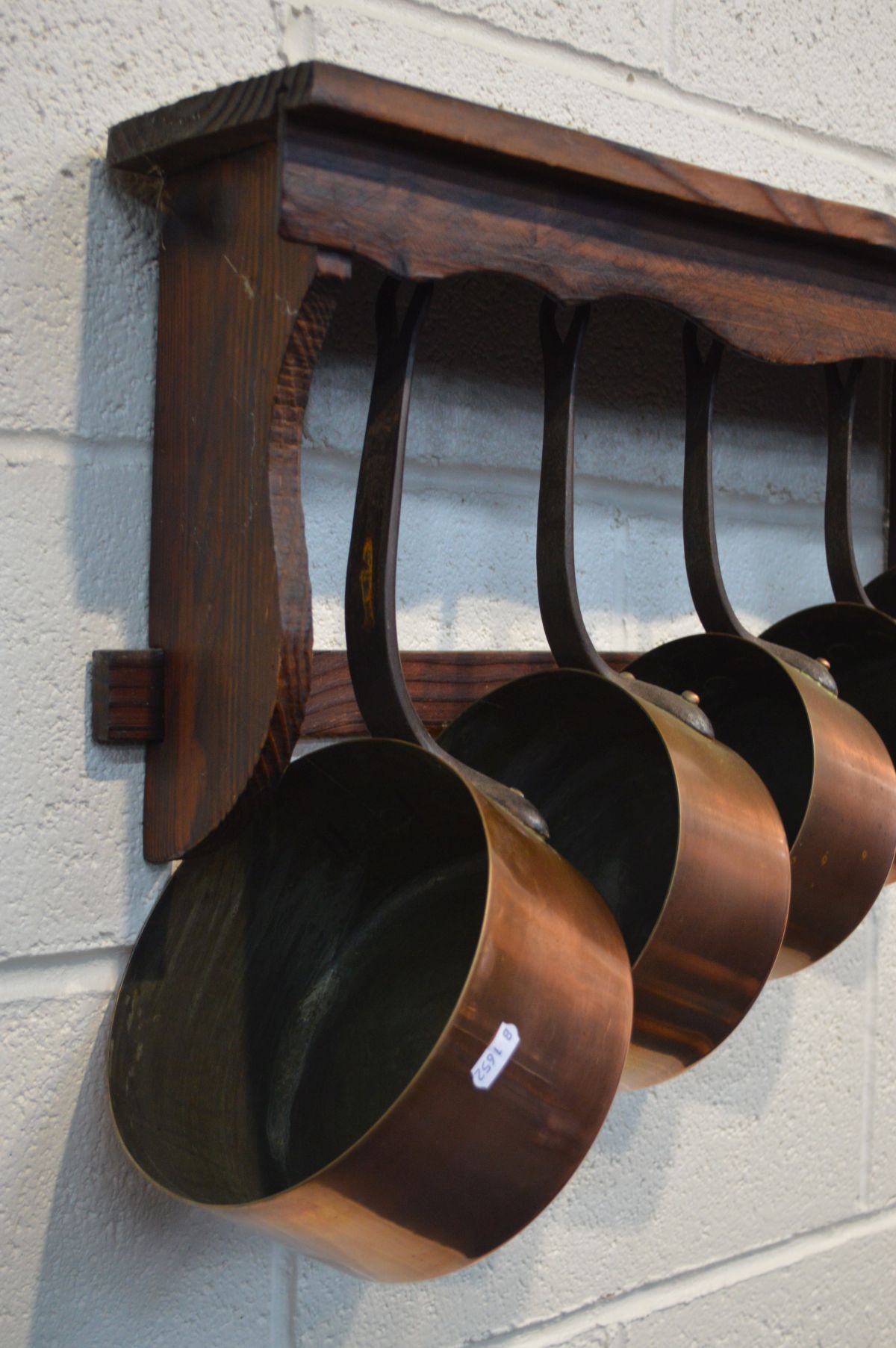 A SET OF FIVE COPPER GRADUATED PANS with hooped iron handles, and a stained pine hanging wall - Image 2 of 2