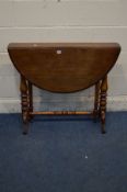 A VICTORIAN WALNUT OVAL CIRCULAR TOPPED SUTHERLAND TABLE, on turned supports to twin scrolled legs