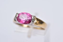 A 9CT GOLD PINK TOPAZ RING, designed with a tension set, oval cut pink topaz, single cut diamond