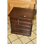 A SMALL EDWARDIAN WALNUT STAINED CHEST OF FOUR DRAWERS CONTAINING NEEDLEWORK EQUIPMENT, etc,