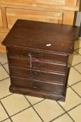 A SMALL EDWARDIAN WALNUT STAINED CHEST OF FOUR DRAWERS CONTAINING NEEDLEWORK EQUIPMENT, etc,