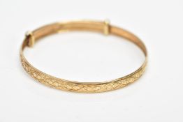 A 9CT GOLD CHRISTENING BANGLE, embossed heart and scroll design, hallmarked 9ct gold Birmingham,