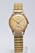 A GENTS 9CT GOLD 'ACCURIST' WRISTWATCH, hand wound movement, discoloured silver dial signed '