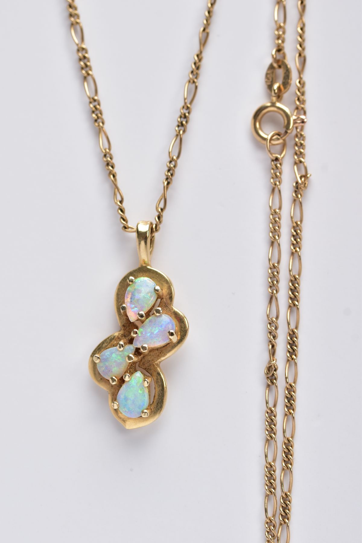 A MODERN FOUR STONE OPAL PENDANT, pendant stamped '14k', together with a Figaro link chain,