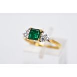 A LATE 20TH CENTURY 18CT GOLD EMERALD AND DIAMOND RING, centring on a square cut emerald measuring