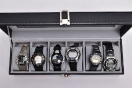 A WATCH DISPLAY CASE WITH DIGITAL WRISTWATCHES, black and glass panelled display case with six